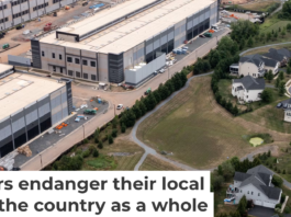 An Amazon data center sits next to a neighborhood in northern Virginia. Nathan Howard/Getty Images